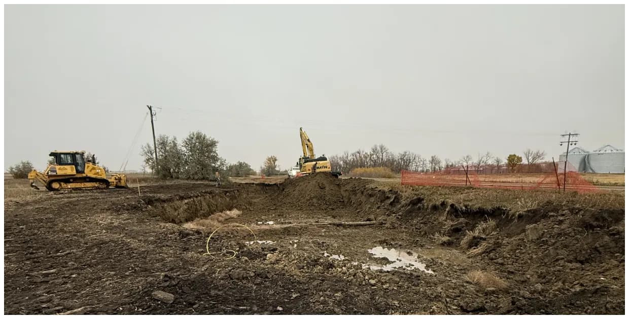 Dozer and excavator on an open remediation site