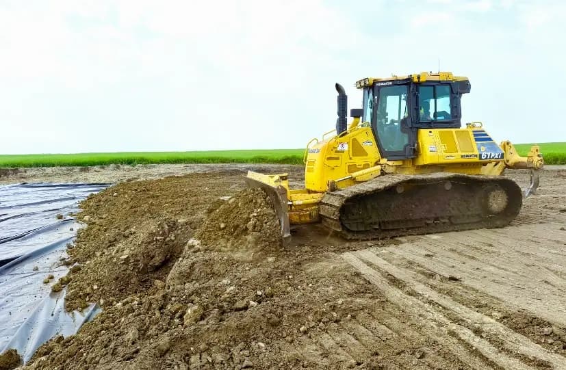 A dozer backfills clay over the liner at Aarhus 4-12.