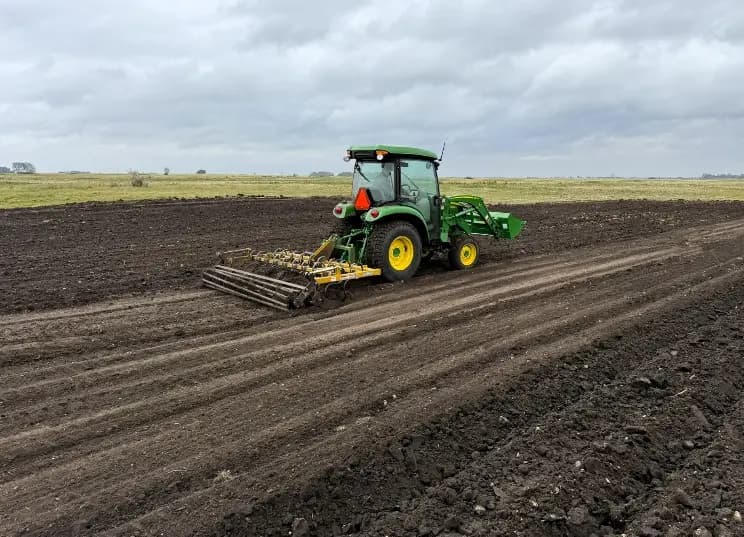 A tractor prepares the restored ground at MRPSU 36-23 South for seeding.