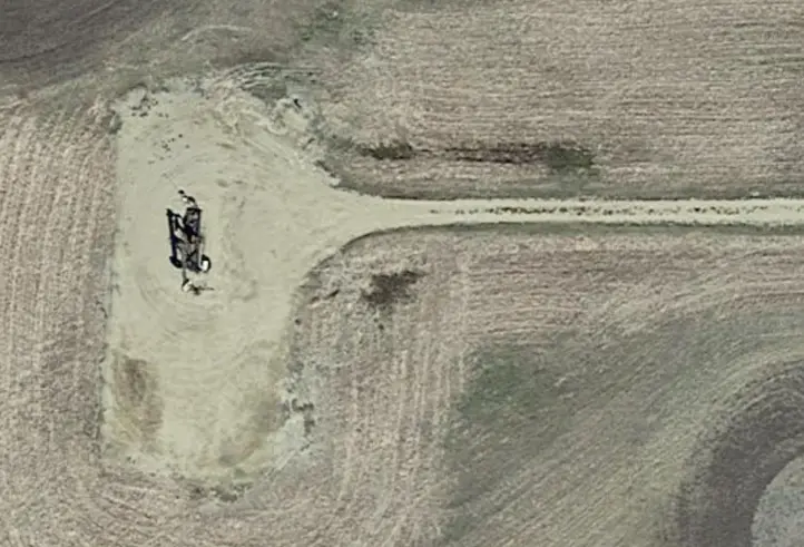 A dozer reshapes a well pad during the NDIC Bid Package #5 reclamation.