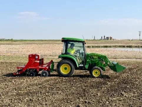 A tractor drills seed into the restored ground at Nelson State 1.