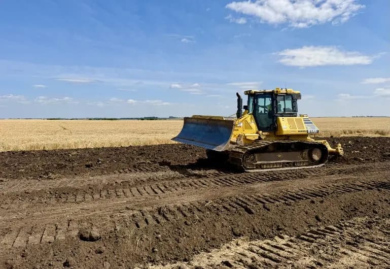A dozer spreads backfill across the excavation at Susan Anderson 1.