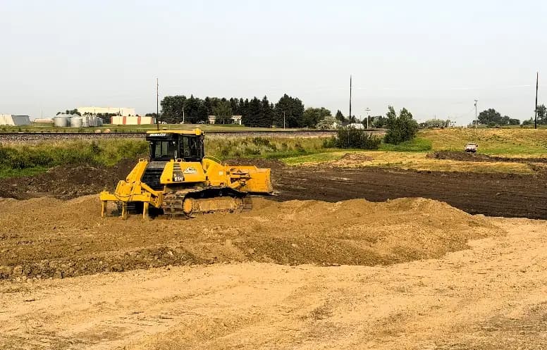 A dozer moves topsoil at the Tioga soccer complex.